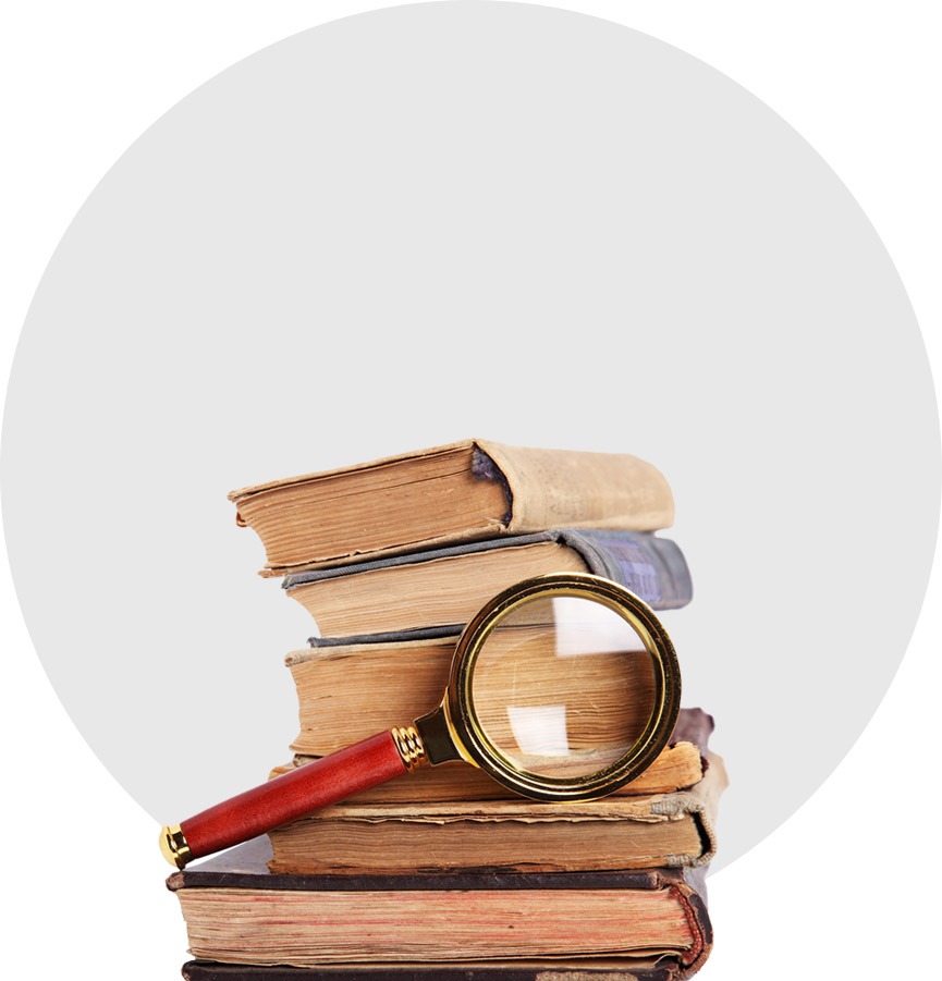Stack of books with magnifying glass 