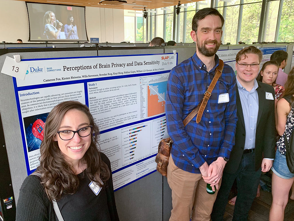 Dr. William Krenzer and two lab particpants posing in front of their poster during the 2018 Bass Connections Poster Session