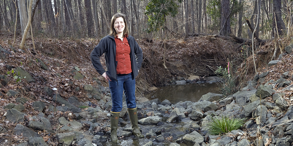 mily Bernhardt at a creek outside the Phytotron Building on Duke’s campus (Photo: Megan Morr)